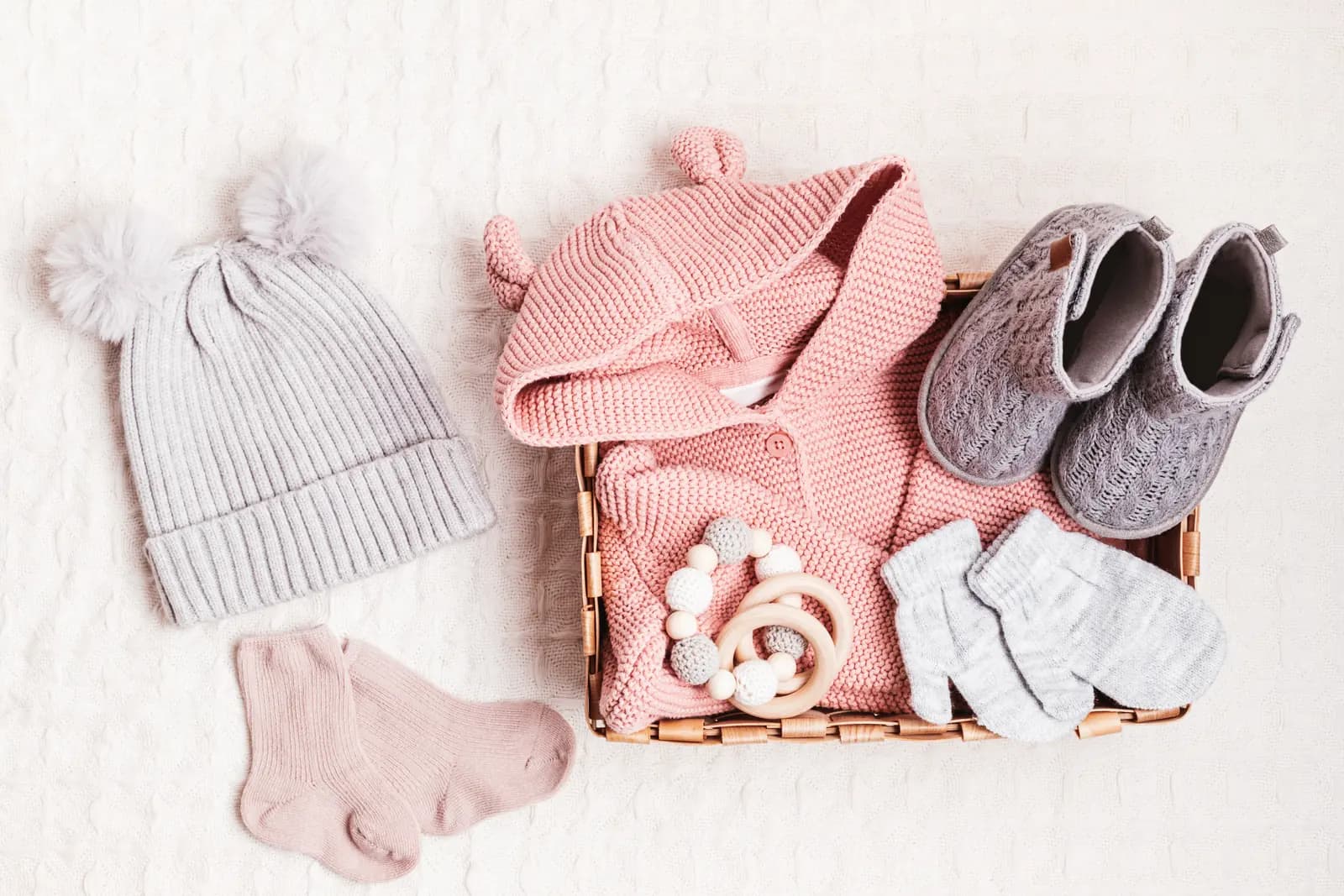 Baby clothes and accessories organized in a basket